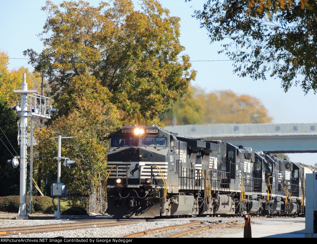 NS 9124 leading a mixed freight train under the new bridge